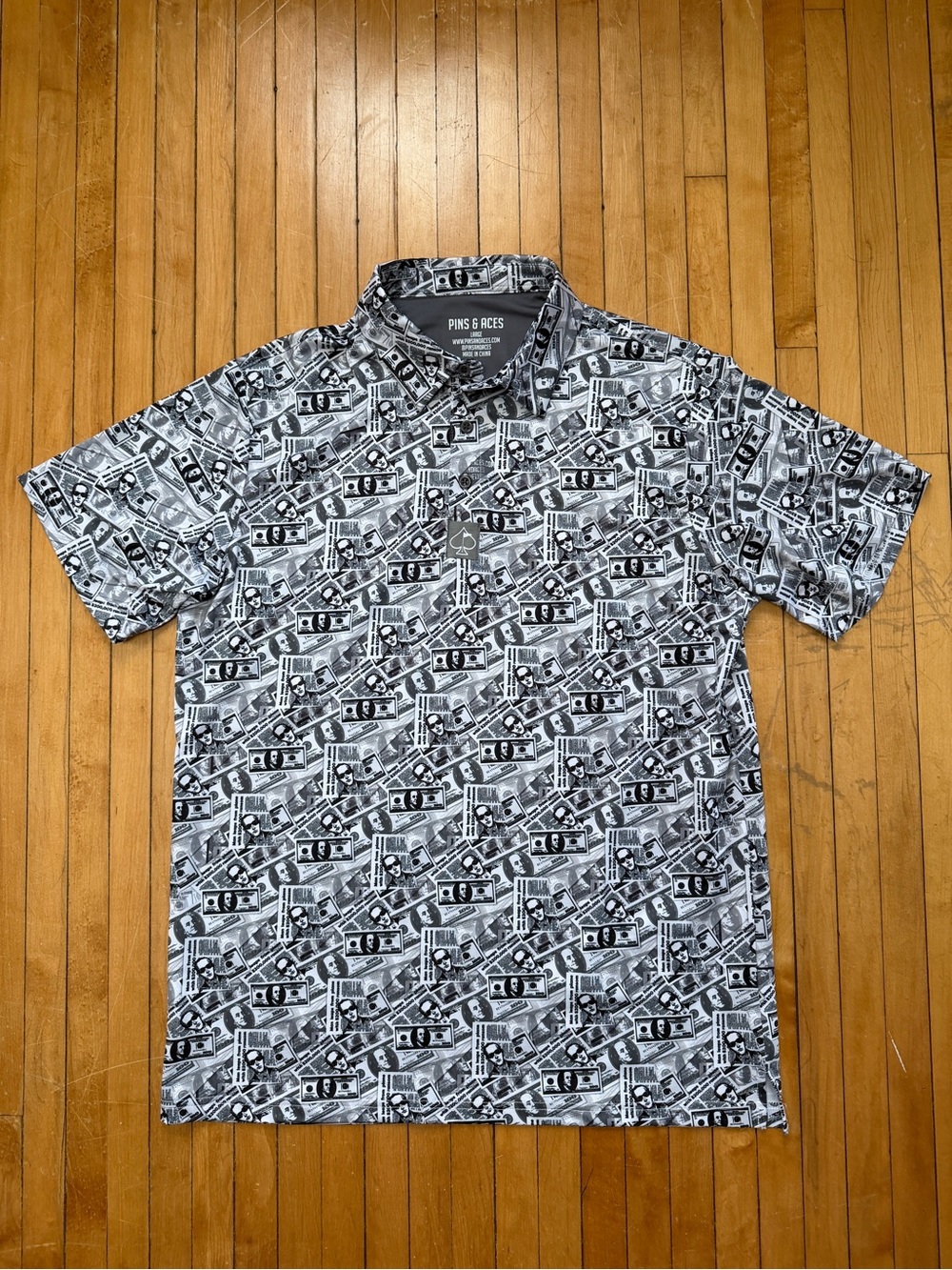 NWOT Pins & Aces DB Cooper Golf AOP Money Dollar Polo Black/White Men’s Sz. L